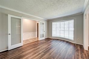 12415 Nova Drive Houston, TX 77077 - Photo 2 of 16 a view of an empty room with wooden floor and a window