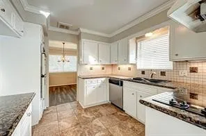 a kitchen with a sink stove and cabinets