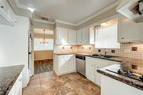 12415 Nova Drive Houston, TX 77077 - Photo 8 of 16 a kitchen with granite countertop a sink stove and refrigerator