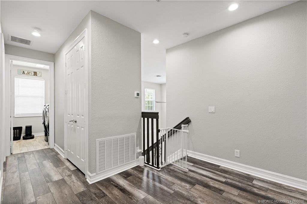1268 Southeast Kirk Street Stuart, FL 34997 - Photo 31 of 63 a view of a hallway with entryway and wooden floor