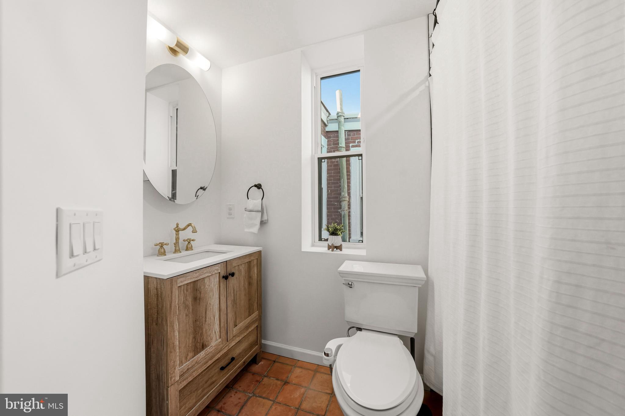 831 North Stillman Street Philadelphia, PA 19130 - Photo 21 of 35 a bathroom with a toilet a sink and a mirror