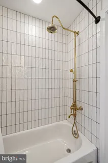 a bathroom with a bathtub and shower