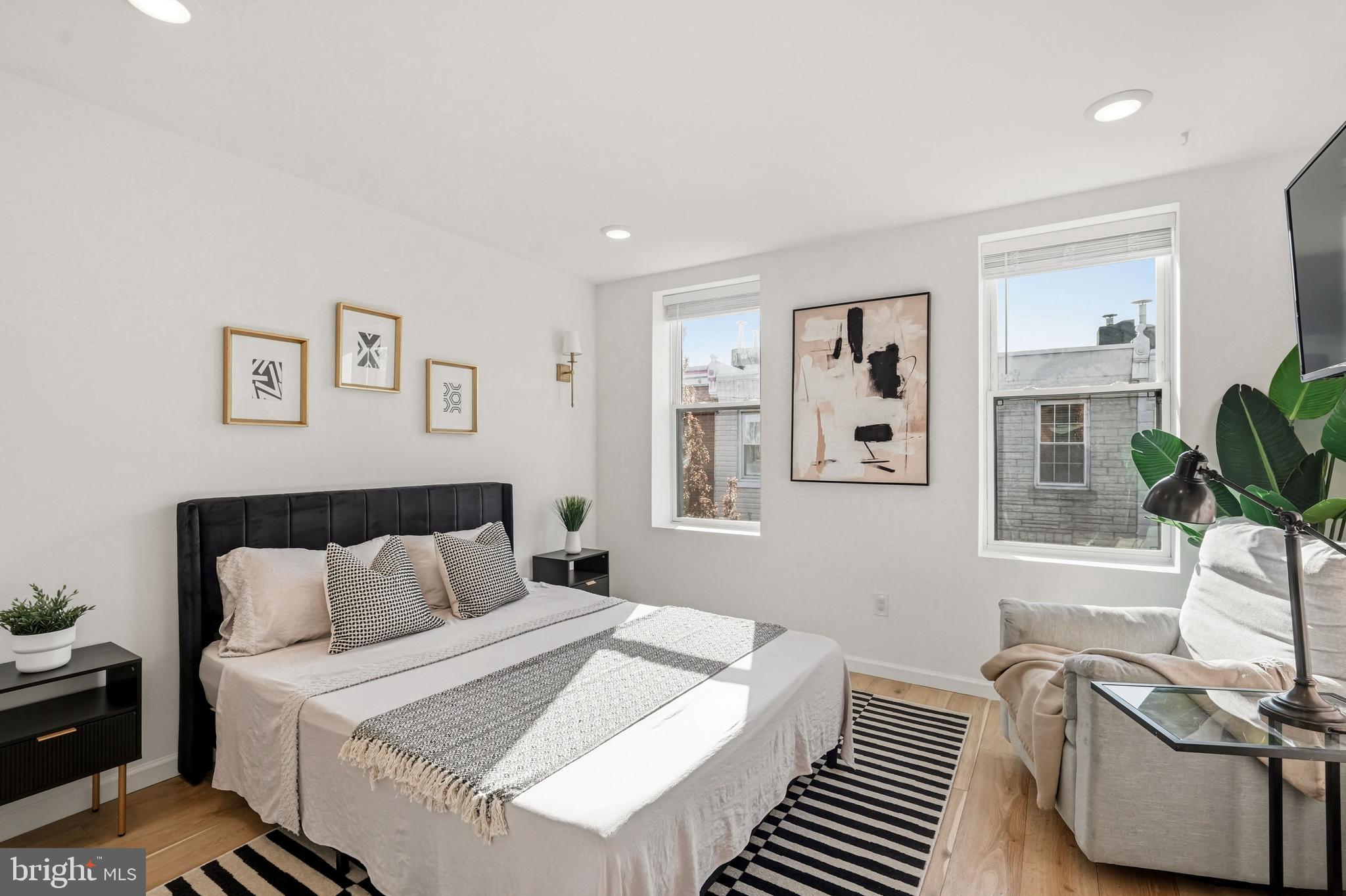 831 North Stillman Street Philadelphia, PA 19130 - Photo 24 of 35 a bedroom with a bed and wooden floor