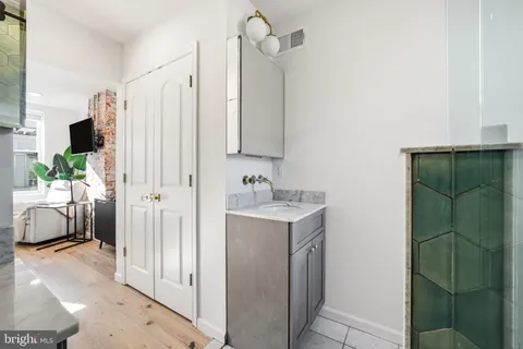 a bathroom with a sink a mirror and a shower