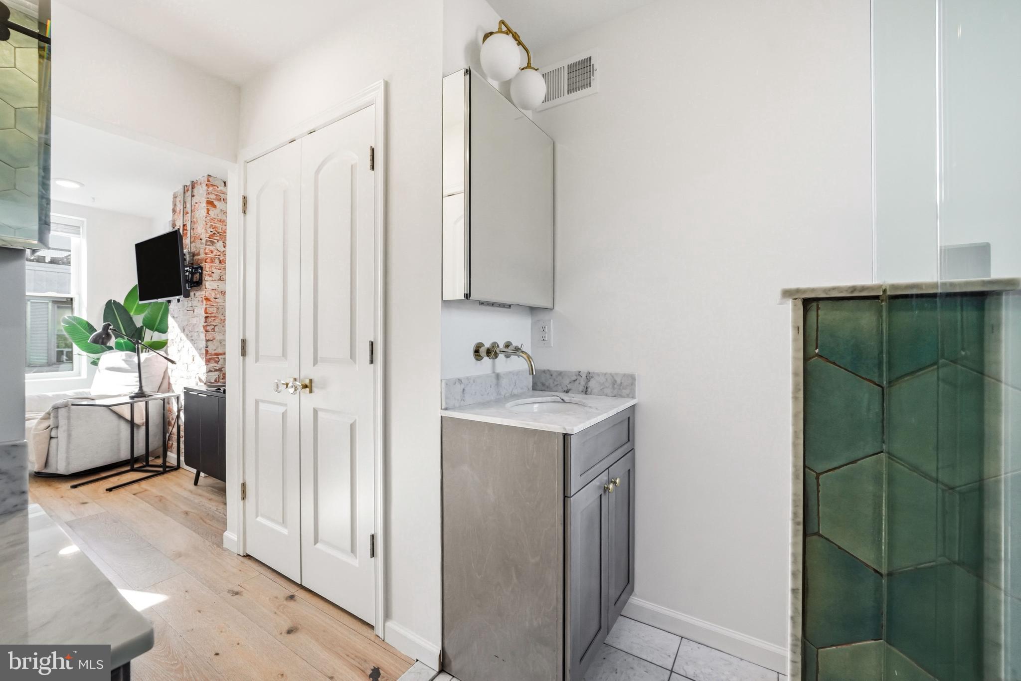 831 North Stillman Street Philadelphia, PA 19130 - Photo 30 of 35 a bathroom with a sink a mirror and a shower