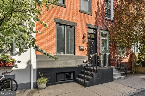 a front view of a house with outdoor seating