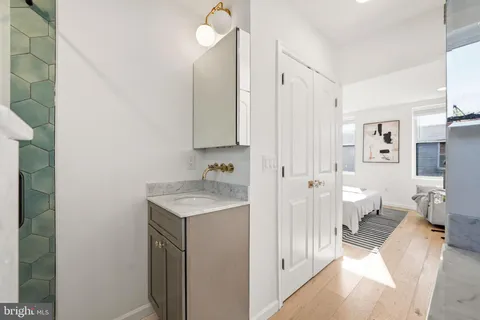 a spacious bathroom with a granite countertop sink a toilet and a shower