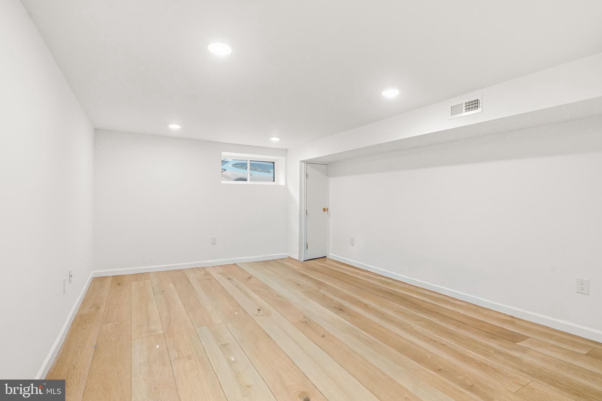 831 North Stillman Street Philadelphia, PA 19130 - Photo 32 of 35 an empty room with wooden floor and windows