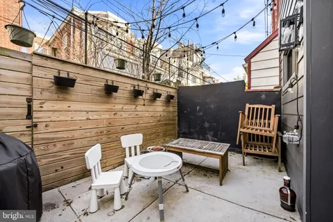 a view of a patio with a table and chairs