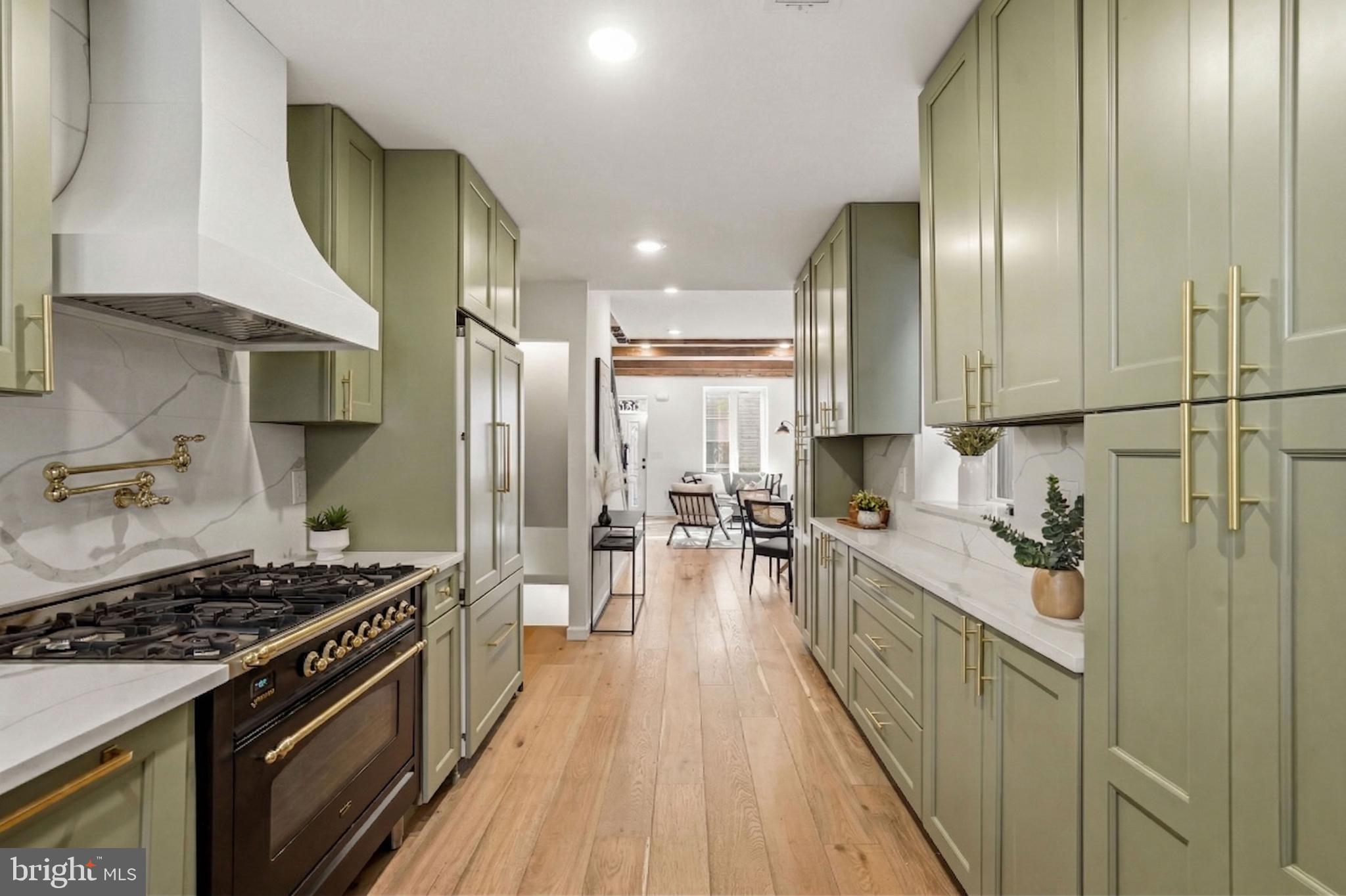 831 North Stillman Street Philadelphia, PA 19130 - Photo 4 of 35 a kitchen with stainless steel appliances granite countertop a stove a sink and a refrigerator