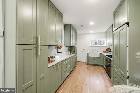 a large kitchen with a large window and stainless steel appliances
