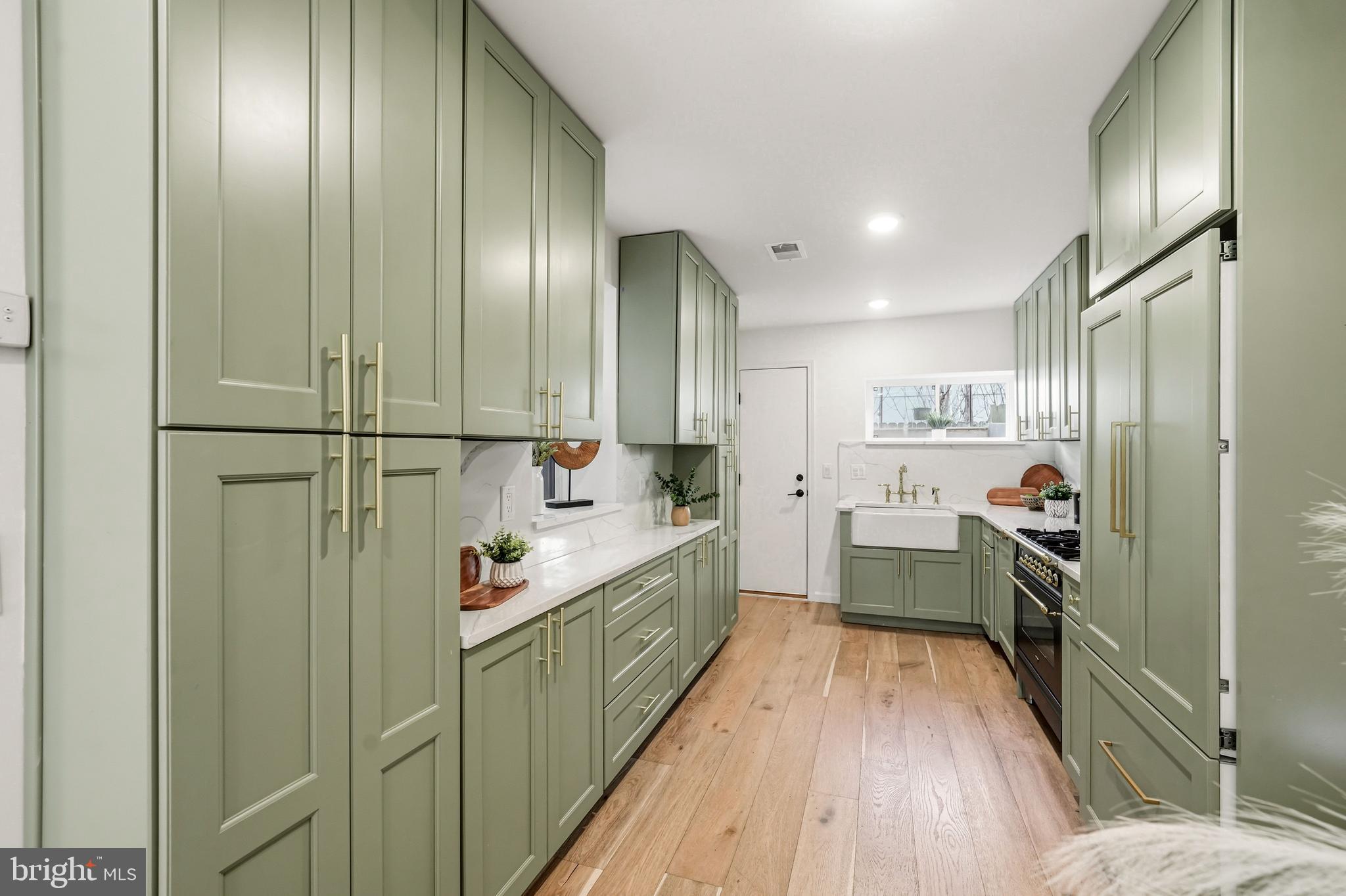 831 North Stillman Street Philadelphia, PA 19130 - Photo 6 of 35 a large kitchen with a large window and stainless steel appliances