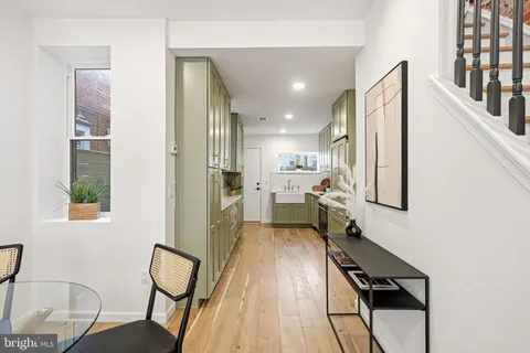 a dining room with furniture and a chandelier