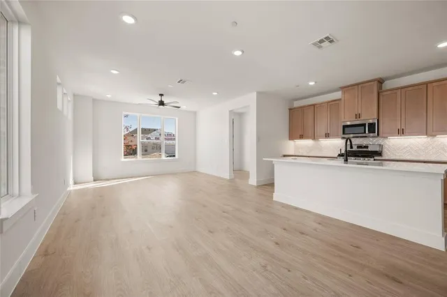 a view of a kitchen with microwave and cabinets
