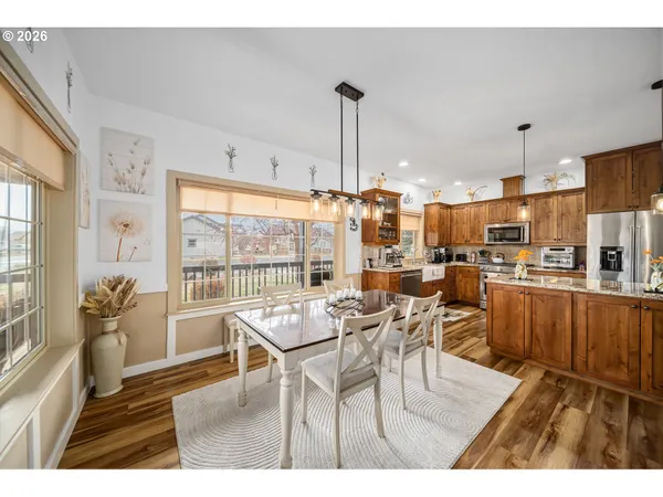 a dining room with furniture a chandelier and wooden floor