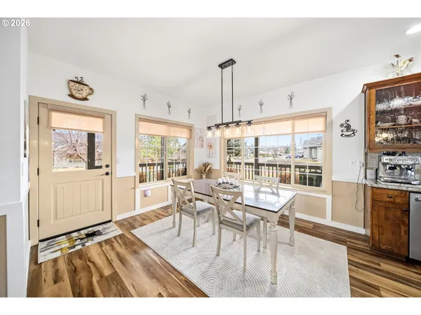 a dining room with furniture and wooden floor