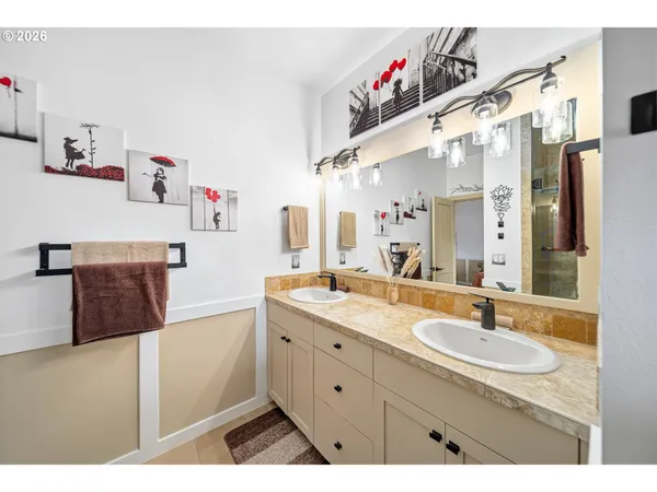 a spacious bathroom with a sink double vanity and a mirror