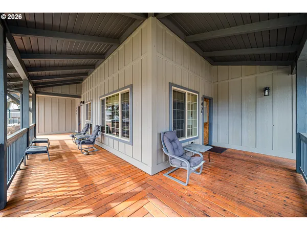 a balcony with furniture and wooden floor
