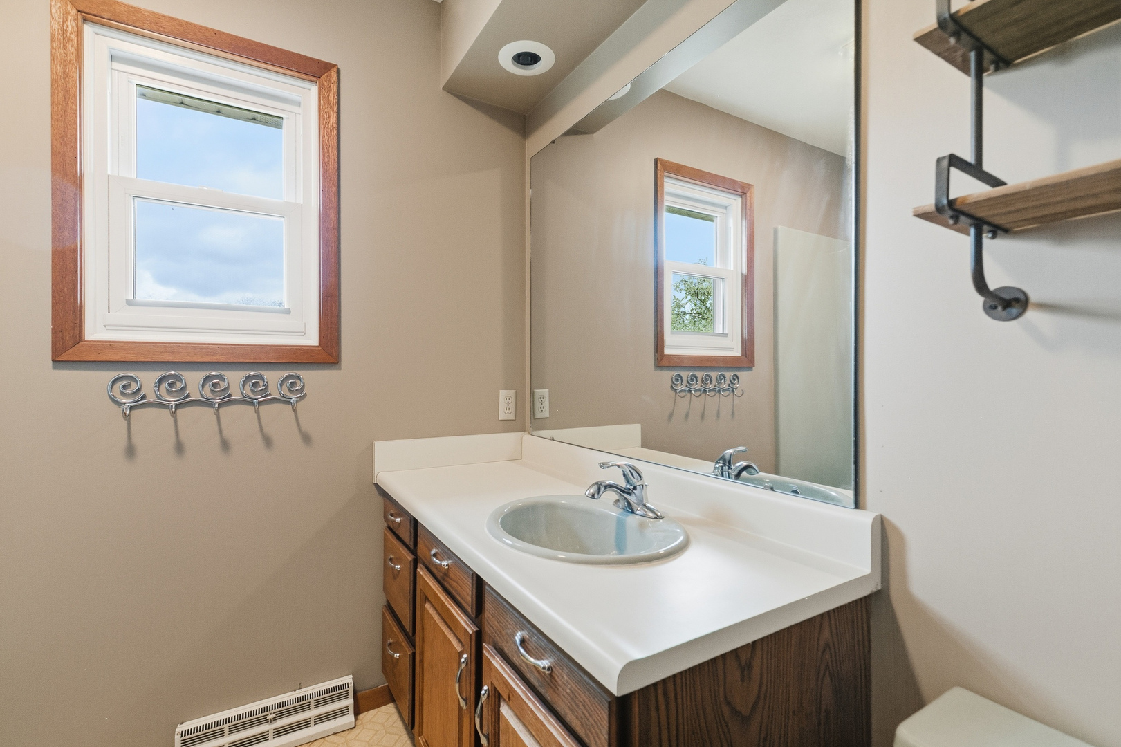 3503 32nd Street Moline, IL 61265 - Photo 28 of 32 a bathroom with a sink a mirror and a window