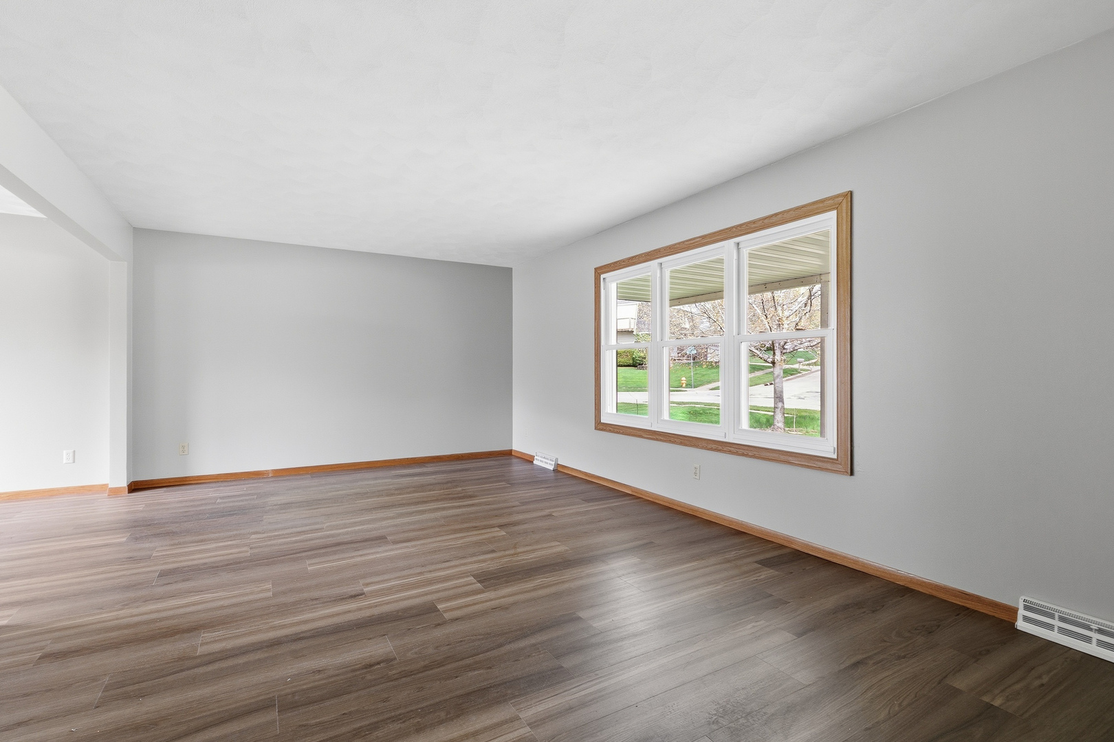 3503 32nd Street Moline, IL 61265 - Photo 8 of 32 a view of an empty room with wooden floor and a window
