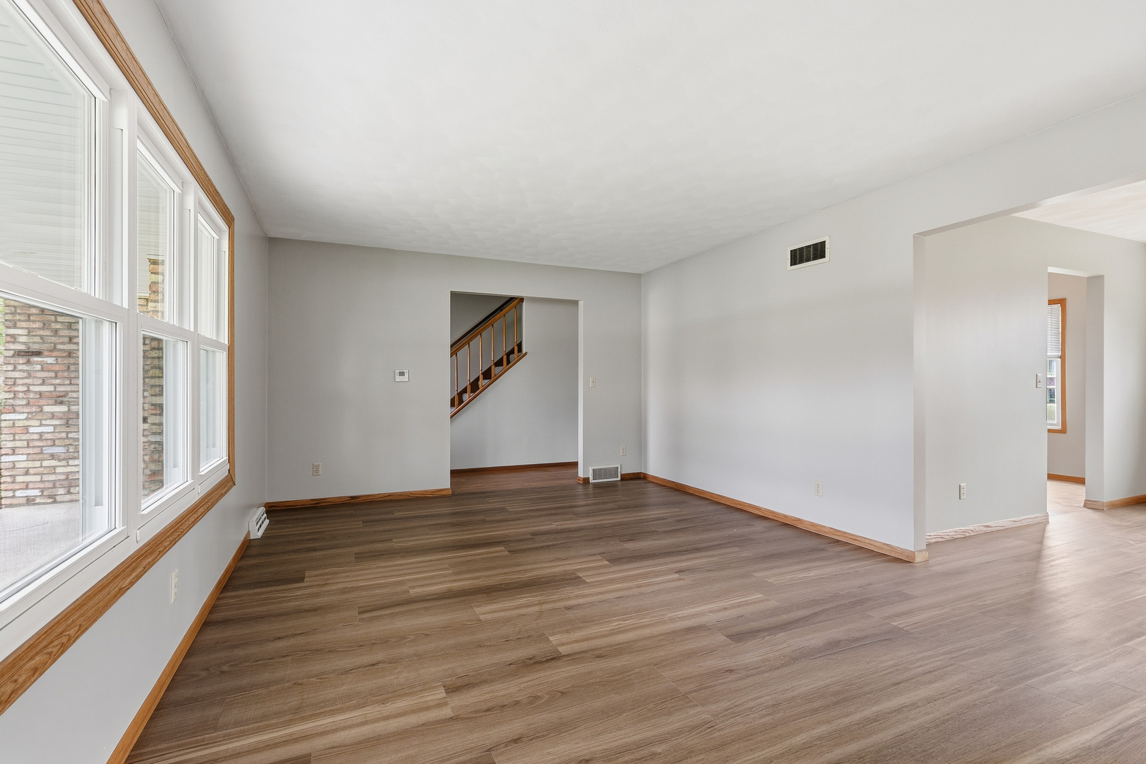 3503 32nd Street Moline, IL 61265 - Photo 9 of 32 a view of an empty room with wooden floor and a window