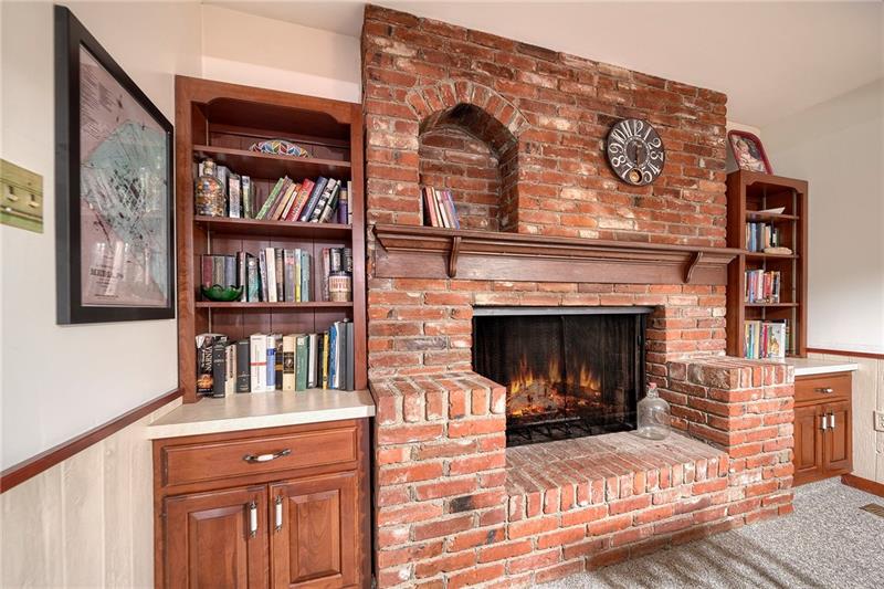 1410 Dutch Ridge Road Beaver, PA 15009 - Photo 9 of 23 Not to be out done by the family room fireplace, the living room fireplace is log burning with this cool hearth & built-ins!