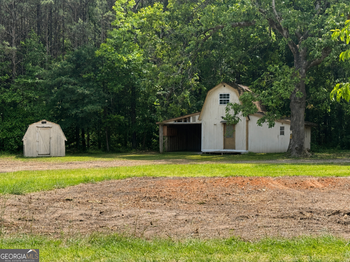 460 Highway 3 Hampton, GA 30228 - Photo 2 of 3 a front view of a house with a yard and trees