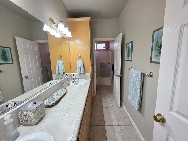 a spacious bathroom with a double vanity sink and a mirror