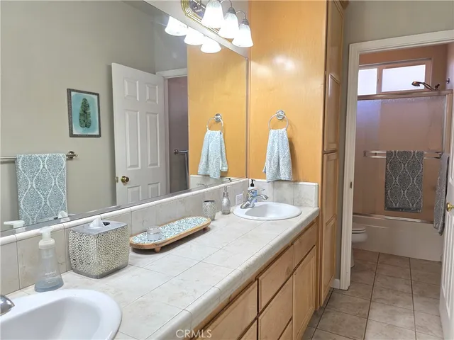 a bathroom with a tub sink and mirror