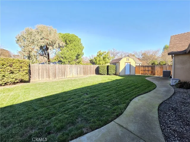 a view of a garden with a building in the background