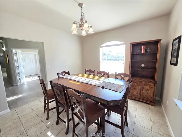 a dining room with a wooden table and chairs