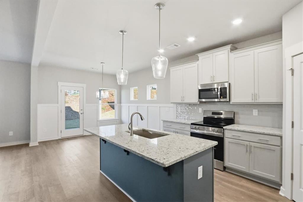 4057 Links Boulevard Jefferson, GA 30549 - Photo 13 of 58 a kitchen with stainless steel appliances granite countertop a sink a stove and a refrigerator
