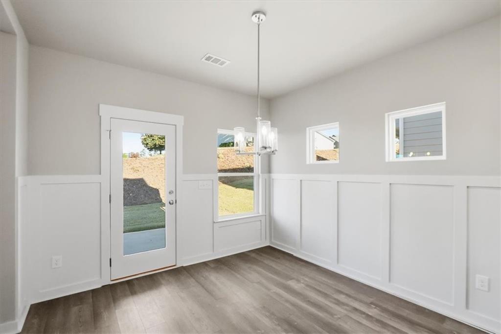 4057 Links Boulevard Jefferson, GA 30549 - Photo 16 of 58 a view of empty room with wooden floor and fan