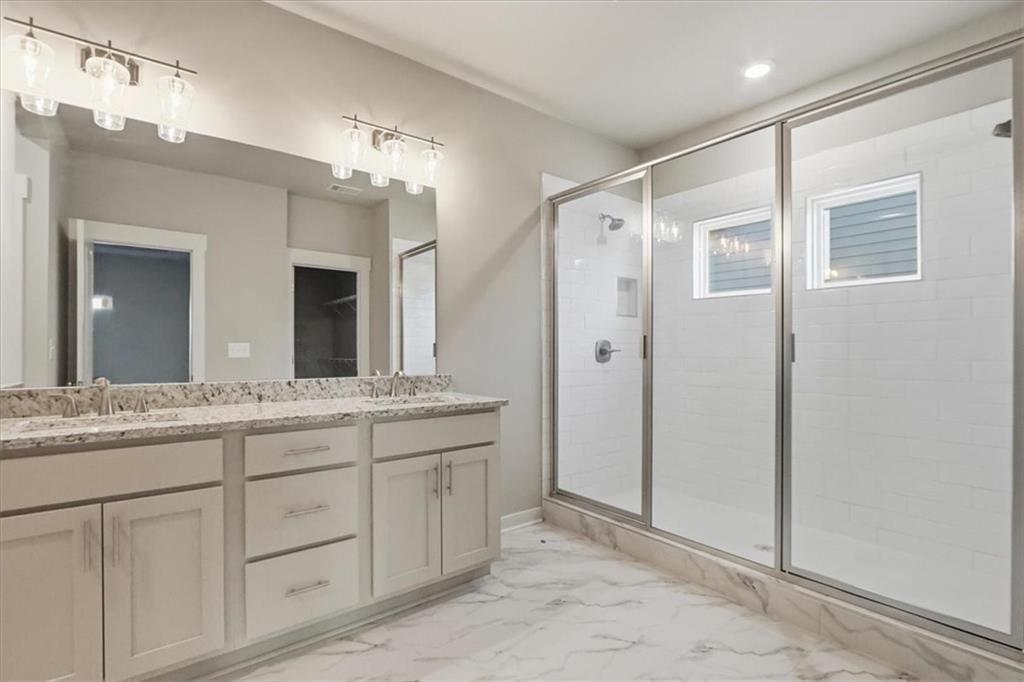 4057 Links Boulevard Jefferson, GA 30549 - Photo 31 of 58 a bathroom with a granite countertop sink mirror and double