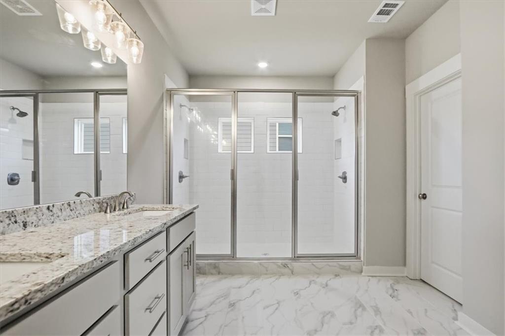 4057 Links Boulevard Jefferson, GA 30549 - Photo 33 of 58 a bathroom with a granite countertop sink and a mirror