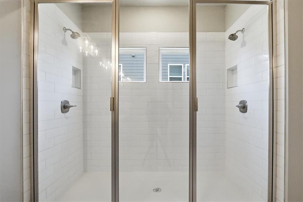 4057 Links Boulevard Jefferson, GA 30549 - Photo 34 of 58 a bathroom with a glass shower door and a glass door