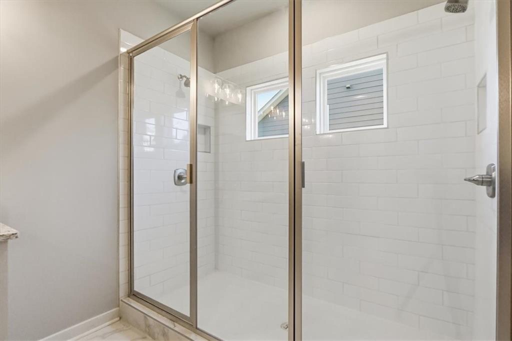 4057 Links Boulevard Jefferson, GA 30549 - Photo 37 of 58 a bathroom with a glass shower door