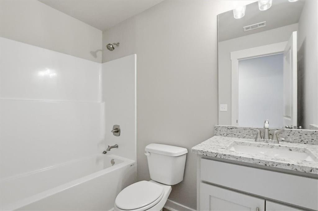 4057 Links Boulevard Jefferson, GA 30549 - Photo 45 of 58 a bathroom with a granite countertop sink toilet and shower