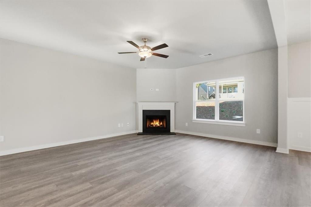 4057 Links Boulevard Jefferson, GA 30549 - Photo 8 of 58 a view of an empty room with wooden floor and a window