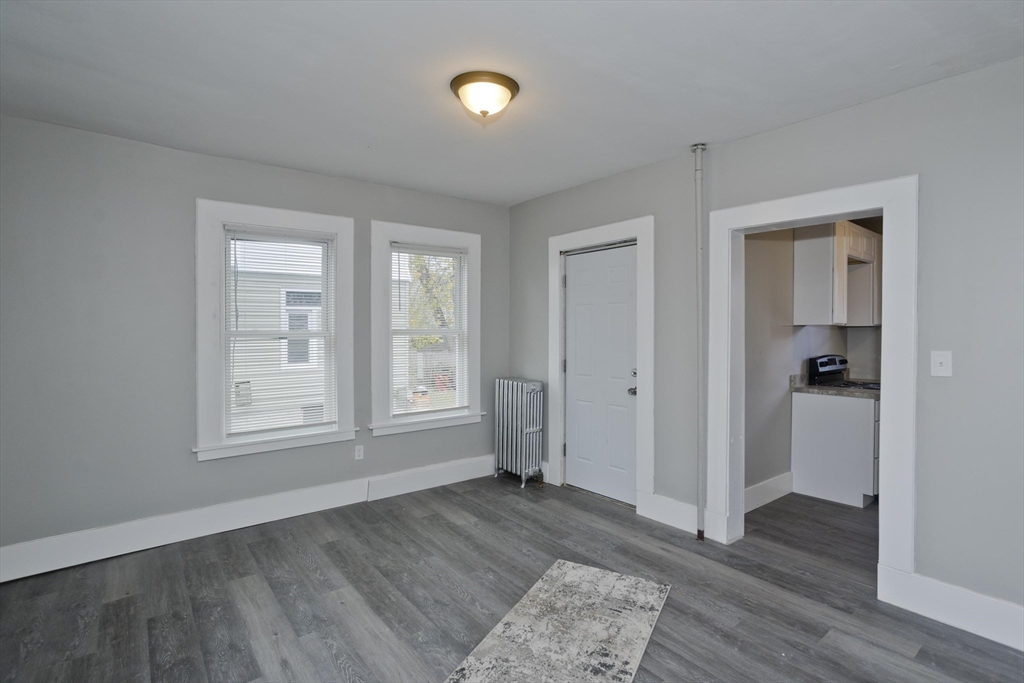 65 Montrose Street Springfield, MA 01109 - Photo 13 of 27 an empty room with wooden floor closet and windows