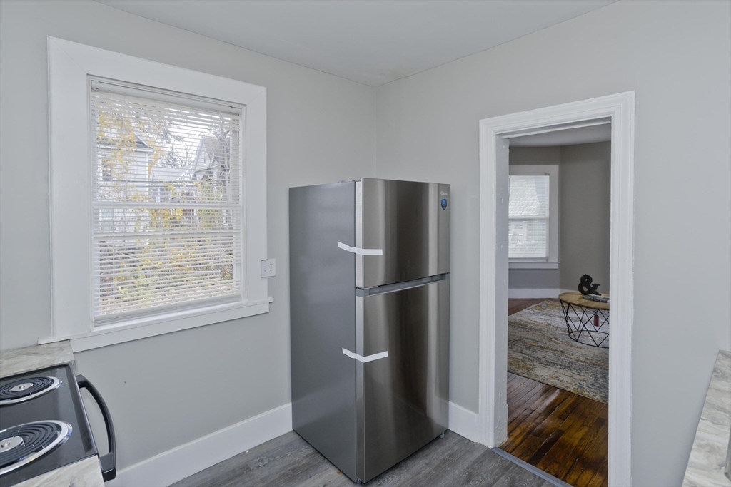 65 Montrose Street Springfield, MA 01109 - Photo 18 of 27 a kitchen with a refrigerator and window