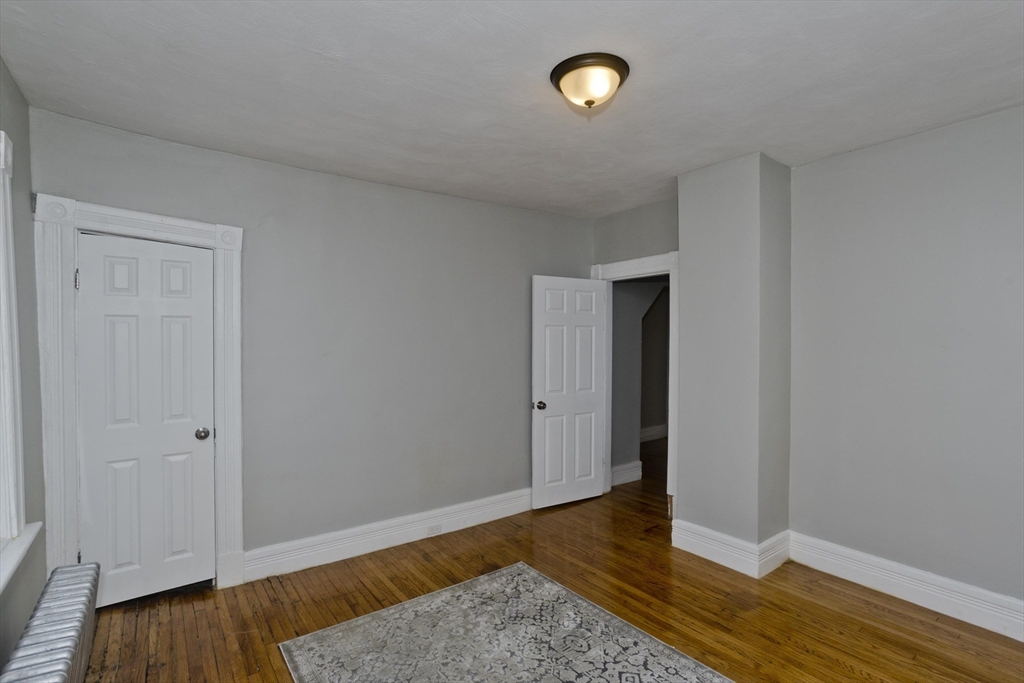 65 Montrose Street Springfield, MA 01109 - Photo 20 of 27 a view of an empty room with wooden floor and closet