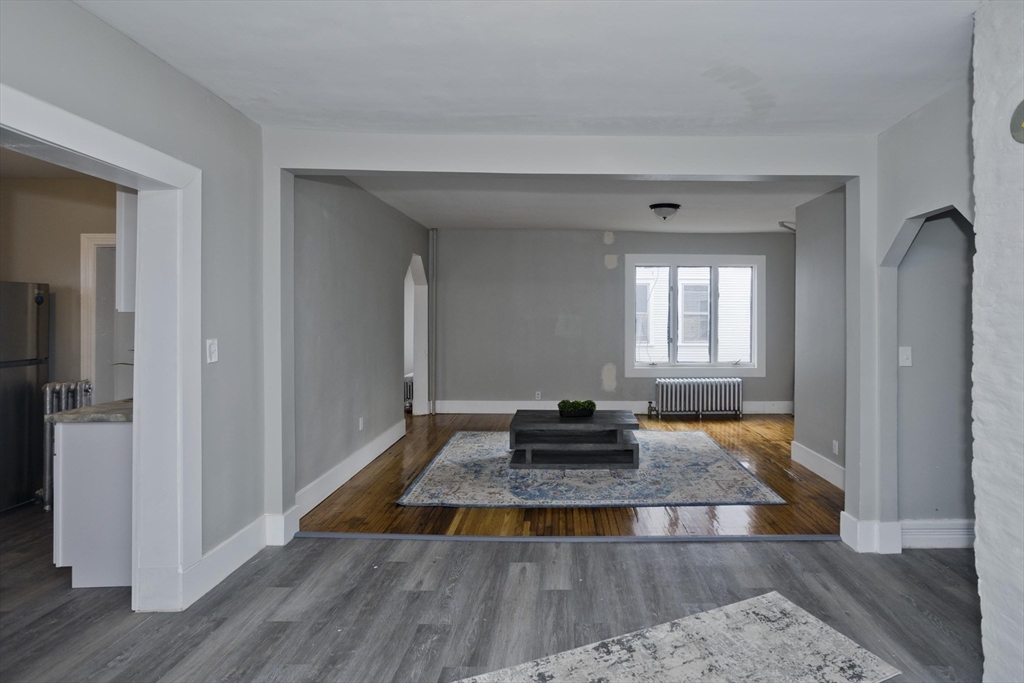 65 Montrose Street Springfield, MA 01109 - Photo 8 of 27 a living room with wooden floor and a window