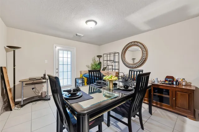 a view of a dining room with furniture and a large window