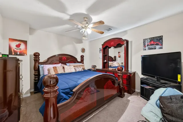 a bedroom with furniture and a flat screen tv