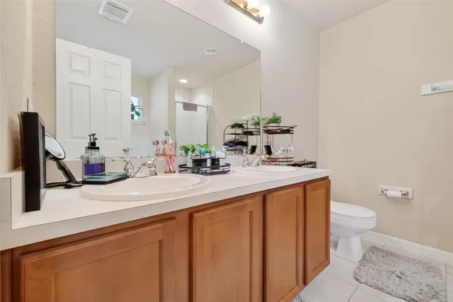 a bathroom with a sink a toilet and mirror