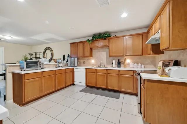 a kitchen with stainless steel appliances granite countertop a sink and cabinets