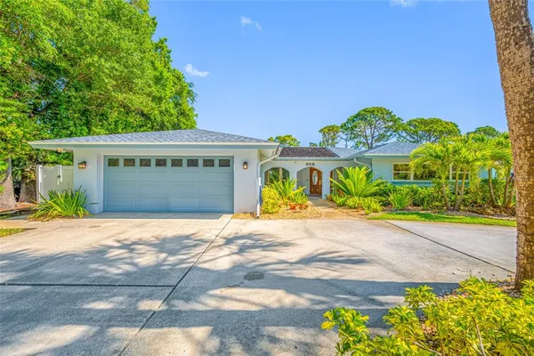 a front view of a house with a yard and a garage