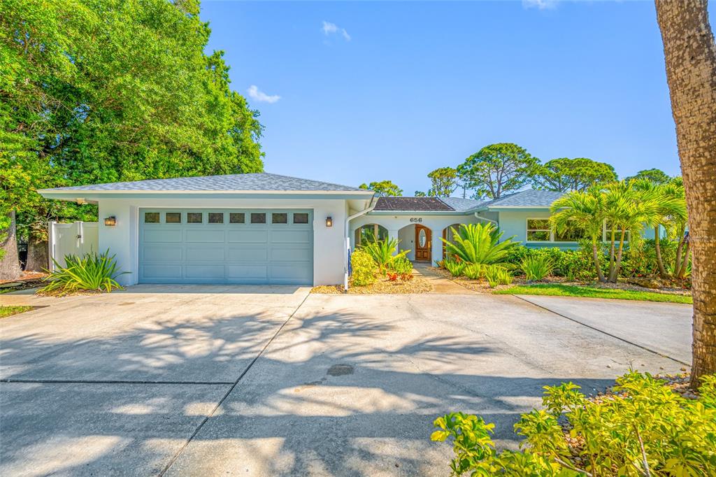 656 Mehlenbacher Road Belleair, FL 33756 - Photo 1 of 49 a front view of a house with a yard and a garage