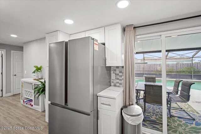 a kitchen with a refrigerator and a table